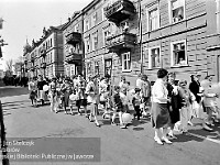 1986-1988-320  1 maja (lata 1986-1988)  Jawor, ul. Poniatowskiego  Obchody 1 maja - Święto Pracy    Uczestnicy pochodu zmierzający w kierunku trybuny honorowej.